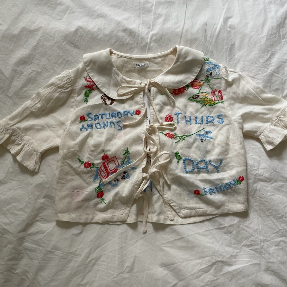 Kimchi Blue Embroidered Tie-Front Days of The Week Peter Pan Collar Top